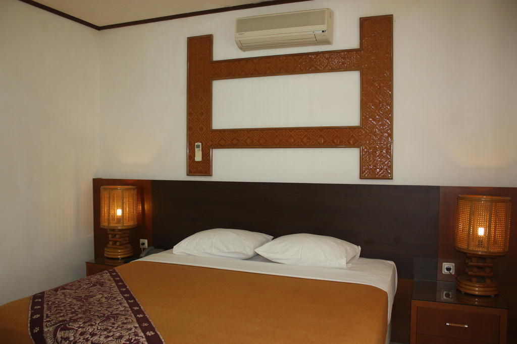 Puri Naga Beachfront Cottages Легиан Номер фото